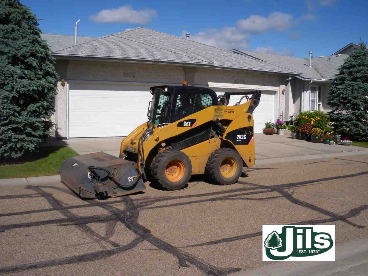 Bobcat sweeping parking lot